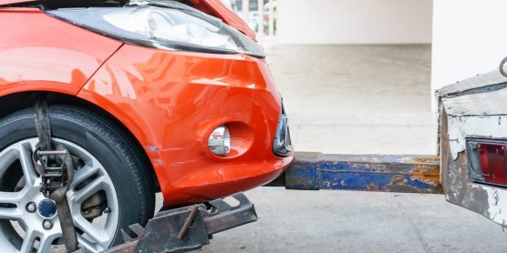 A car getting safely towed away on a suburban street