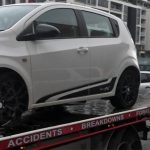 A car with a flat tyre and other things wrong with it on the back of a Fast Sydney Tow Truck.