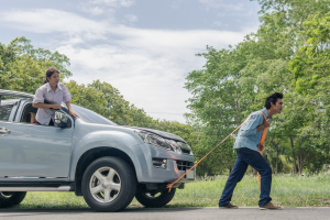 A person attempting to tow a vehicle them selves from an accident. 