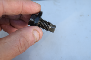 A car oil drain plug used to release old car oil that needs to be drained.