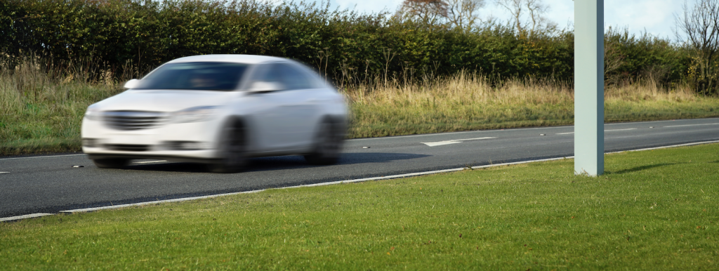 A car getting caught by a speed camera.