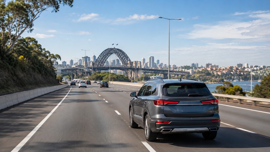 Fuel-efficient SUV driving on a Sydney motorway near the Harbour Bridge