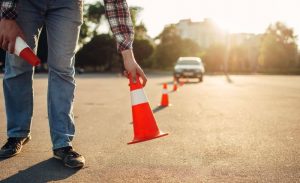 Driving instructor setting cones.