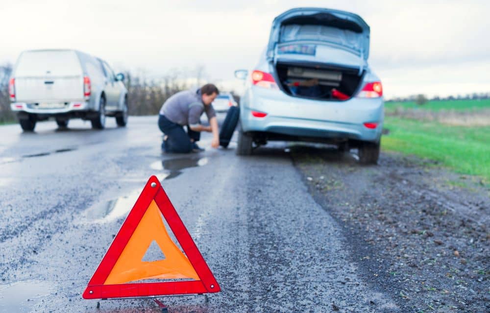 Changing tyre, roadside.