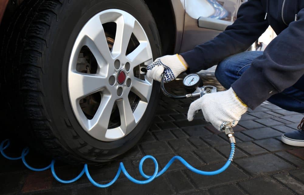 Mechanic checking tyre pressure.