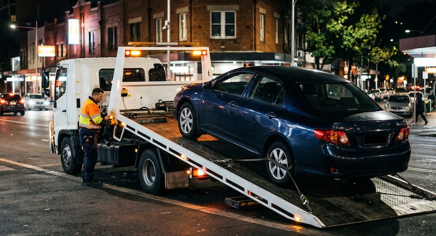 Tow truck assisting a broken down vehicle in Sydney as petrol prices impact towing costs
